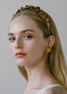 Each Rowena Headband is constructed by hand in our Brooklyn sudio, so each one is one-of-a-kind and no two are entirely alike. Featuring a combination of golden blooms and life-like foliage, the Rowena evokes an ethereal, Grecian mood, and can be worn atop the head like a headband, or in the back of the head, framing an up-do or loose waves. For the perfect wearing, wear this headband with the coordinating Rowena Earrings. Dimensions: 6.75 x 6 inches, 1.5 inches height Weight: 97g Floral Headband Wedding Guest, Bridal Styling, Luxury Hair Accessories, Jennifer Behr, Floral Studs, Gold Rings Fashion, Gold Headband, Luxury Hair, Antique Earrings