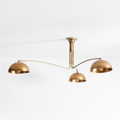 three brass colored lights hanging from the ceiling