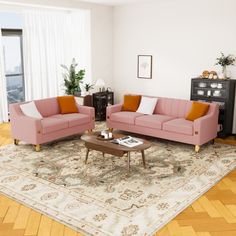 a living room with two couches and a coffee table in front of a window