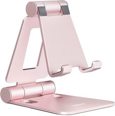 a pink cell phone holder on top of a laptop