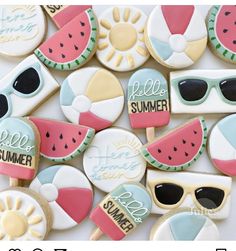 some cookies that are decorated to look like watermelon and sun glasses on top of each other