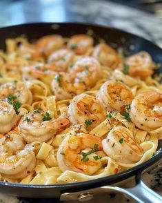 pasta with shrimp and parsley in a skillet