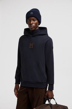 Exploring the collection's interpretation of elevated minimalism, this hooded sweatshirt is crafted from soft cotton fleece. The design is completed by a subtle monogram patch in suede. Luxury Blue Sporty Hoodie, Luxury Sporty Blue Sweatshirt, Blue Hooded Sweatshirt With Logo Detail, Luxury Garment-dyed Hoodie Sweatshirt, Moncler Sweatshirt, Bubble Coat, Personalized Jacket, Cardigan Shirt, Down Vest