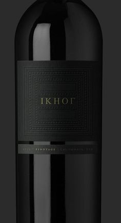 a bottle of red wine is shown on a black background with the word i k hot written in gold