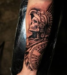 a man's arm with a tattoo on it and a skull in the middle