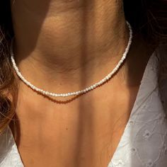 This delicate necklace is crafted with 2mm natural freshwater pearls for a minimalist and elegant look. Perfect for everyday wear or special occasions, the pearls radiate timeless beauty.  The necklace is designed with durable stainless steel findings and chain, ensuring it's resistant to tarnishing and suitable for long-term use. The adjustable chain allows for a customized fit, making it an ideal gift for anyone who loves dainty and sophisticated jewelry. Whether you're looking for a stylish p Tiny Pearl Necklace, Sophisticated Jewelry, Necklace Everyday, Necklace Minimalist, Seed Pearl, Pearl Choker, Minimalist Necklace, Delicate Necklace, Necklace Gift