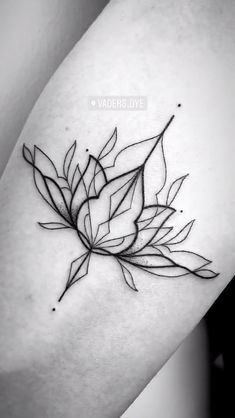 a black and white photo of a leaf tattoo