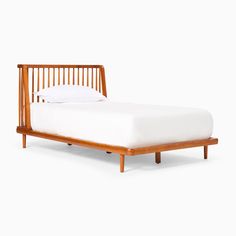 a wooden bed frame with white sheets and pillows on it's headboard, against a white background