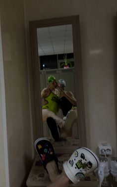 a person is taking a selfie in front of a mirror with their shoes on