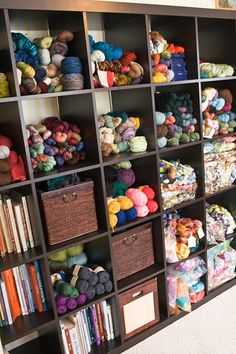 a book shelf filled with lots of yarn