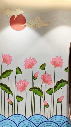 a wall with flowers painted on it next to a mirror