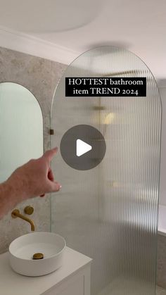 a person pointing at a bathroom mirror with the text hot test bathroom item trend 2012