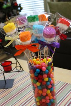 a vase filled with candy and candies on top of a table