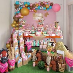 a table filled with lots of desserts and decorations on top of green carpeted flooring