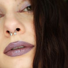 a close up of a person with a nose piercing