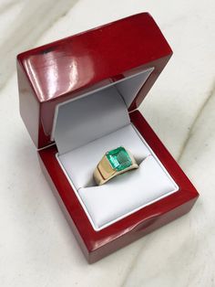 This men's sleek 14K gold ring says it all. This ring is made with good quality and genuine materials from our emerald collection. The emerald-cut gemstone is natural and comes directly from Colombia, a country known for the finest quality emeralds in the world. The gem featured in this ring is of very good color and eye clarity. The emerald is prong-set in 14K gold. The band is smooth and effortless. The ring is comfortable for daily wear. Setting Style: Solitaire Ring Setting Material: 14K Gol Formal Emerald Cut Emerald Ring With Tension Setting, Modern Emerald Signet Ring For Formal Occasions, Modern Emerald Cut Emerald Signet Ring, Formal Emerald Signet Ring With Prong Setting, Gold Mens Ring, Solitaire Ring Set, Etsy Gold Ring, Colombian Emeralds, Emerald Engagement