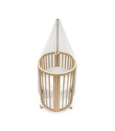 a wooden crib with a white canopy over it