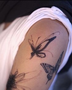 a woman with a butterfly tattoo on her arm