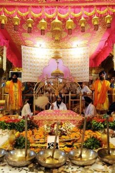 a group of people sitting around a table with food on top of it in front of a stage