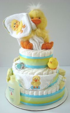 a diaper cake with a stuffed duck on top