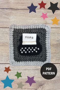 a crocheted photo frame with a typewriter on it and stars in the background