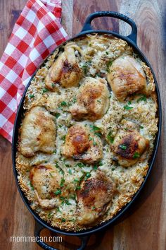 chicken and rice casserole in a cast iron skillet on a wooden table