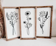 three framed art pieces with flowers on them