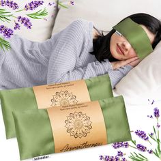 a woman laying in bed with her eyes closed next to two pillows and lavender flowers