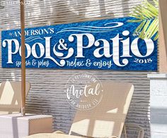 two chairs sitting under an umbrella in front of a sign that says pool and patio