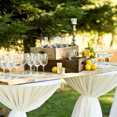 the table is set up with wine glasses and lemons for an elegant wedding reception