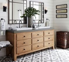 a bathroom with two sinks and mirrors on the wall