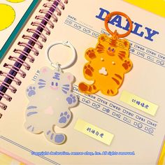 a notebook with a tiger shaped keychain on it