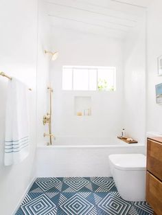 a bathroom with blue and white floor tiles