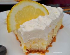 two slices of cheesecake with lemons on the side