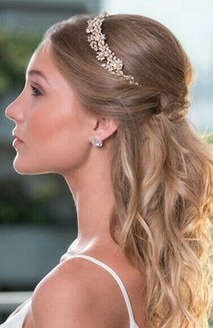 a woman with long blonde hair wearing a headpiece in the shape of a tiara