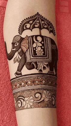 an elephant tattoo is shown on the leg