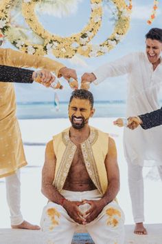 two men are getting ready to cut another man's hair