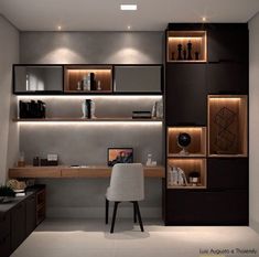 a modern home office with built - in shelving units and lighting on the wall