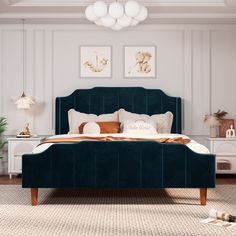 a green velvet bed frame in a white bedroom