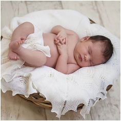 a newborn baby is sleeping in a basket