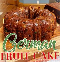 a german fruit cake on a wooden cutting board with the words, german fruit cake