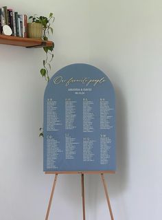 a blue sign sitting on top of a wooden easel next to a book shelf