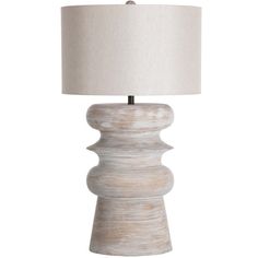 a white table lamp with a beige shade on the base and a light bulb in the middle