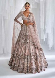 Editor's Note Featuring a pale pink shimmer tulle bridal lehenga with pearl embroidery, tulle dupatta and a tulle head veil and an embroidered blouse. Fabric: Tulle Color: Pale pink Components: Lehenga, blouse and dupatta Occasion: Wedding Care: Dry Clean Only Customize Your Outfit Can't find the size you're looking for? No stress. Just select the size "Custom" while adding the item to your cart. We will follow up with you for your body measurements. To request a color or design customizations, Dolly J, Head Veil, Pink Bridal Lehenga, Pearl Embroidery, Pink Bridal, Pink Tulle, Bridal Lehenga, Bride Bridal, Bridal Dress