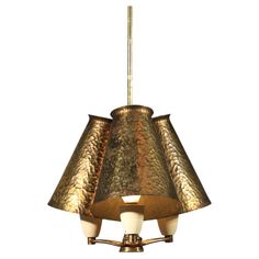 a brass colored chandelier hanging from the ceiling