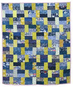 a blue and yellow patchwork quilt