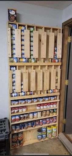 a wooden pallet filled with canned food and cans on it's shelves next to a door