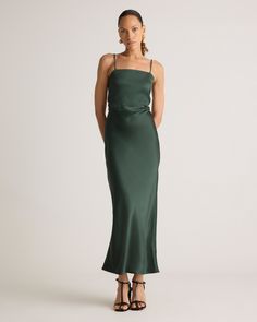 a woman is wearing a green dress with spaghetti straps and an open - back design