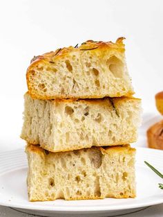 three pieces of bread stacked on top of each other with rosemary sprigs in the background