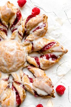 raspberry scones are arranged in a circle on a plate with white icing